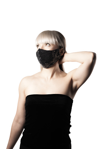 Beautiful brunette girl with blond hair fringe bangs wearing black fashionable protective face mask.