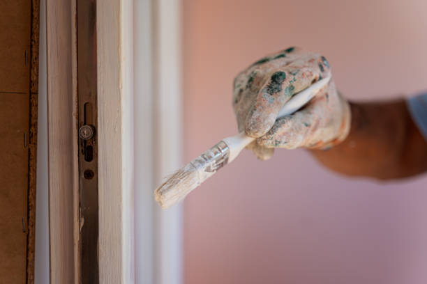 istock Applying protective varnish on a wooden door 1415677238