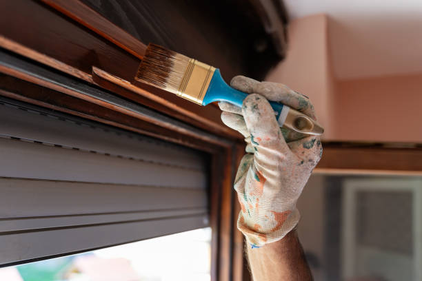 istock Senior man applying protective varnish on a wooden window 1415677258