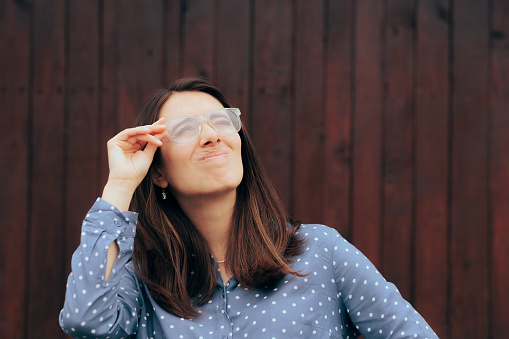 Frustrated lady having problems with her new pair of glasses