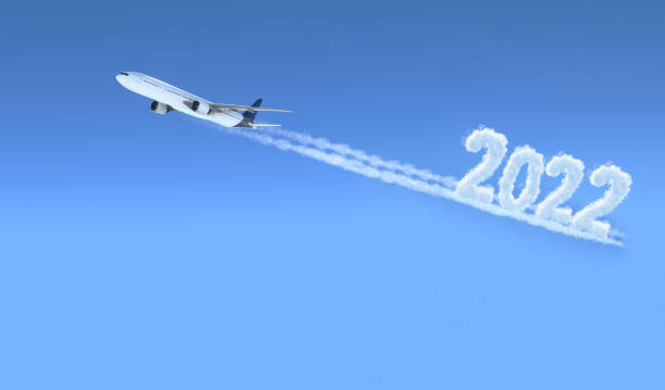istock Commercial plane flying with 2022 smoke writing 1415680738