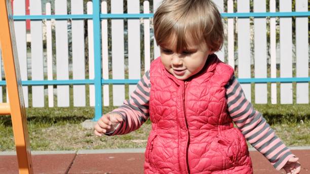istock Baby playing on a playground in spring. 1415682353