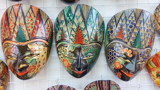 Close up of three traditional Indonesian wooden masks