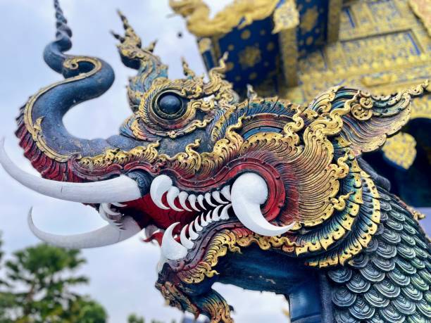 Dragon head from Blue temple in Chiang Rai Sculpture showing the head of a blue dragon in the Blue Temple in Chiang Rai chiang rai province stock pictures, royalty-free photos & images