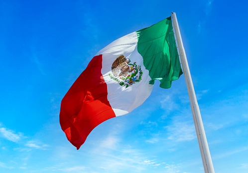 Los Cabos San Jose Del Cabo, Mexico, Mexican tricolor national striped flag proudly waving at mast.