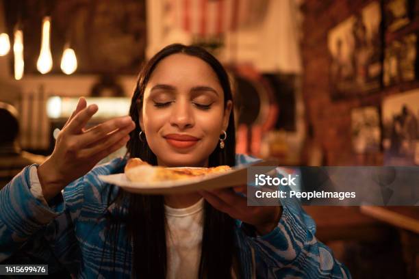 Hungry Woman With Delicious Pizza Food Or Consumables At A Bar Restaurant Or Diner At Night One Happy And Casual Girl Foodie Or Tourist Enjoying A Dinner Meal At A Local Trendy Location Stock Photo - Download Image Now