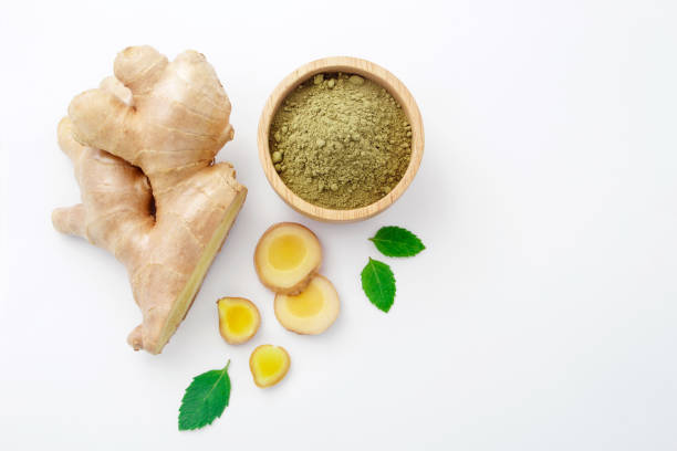 istock Ginger sliced with ginger powder in bowl and mint leaf on white paper background. 1415704420