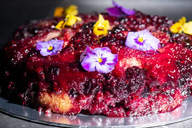 Home-made upside-down cake with mixed berries including organic strawberries, blueberries, blackberries, and raspberries.