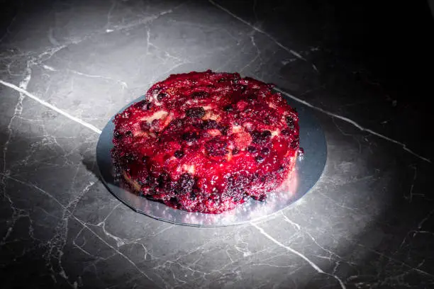 Home-made upside-down cake with mixed berries including organic strawberries, blueberries, blackberries, and raspberries.