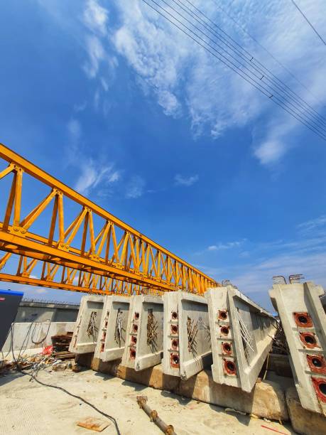 istock Several girders are arranged below yellow launcher gantry 1415708121