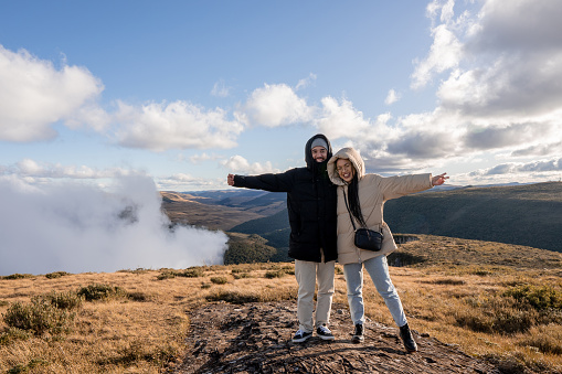 Portrait of tourist couple on top of the mountain