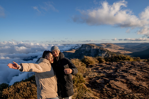 Couple taking selfie from the top of the mountain