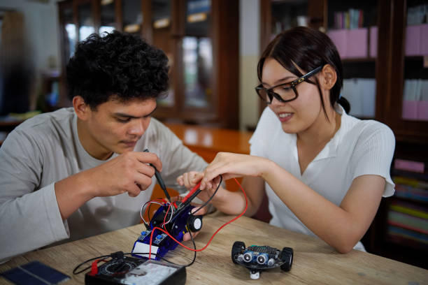 istock Asian young man and girl work on technology experiment project at school,technology concept, 1415713798