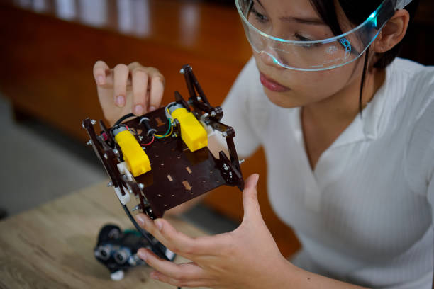 istock asian girl work on technology experiment project at school,technology concept, 1415713799