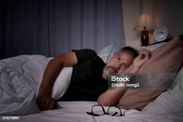 Depressed Old Man And Stressed Lying In Bed From Insomnia Stock Photo - Download Image Now