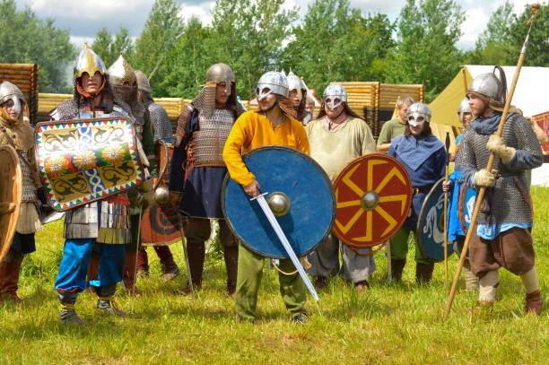 epic invading army of medieval knights on battlefield, plate body armored soldiers with swords in battle cry. historical reenactment. - history knight historical reenactment military imagens e fotografias de stock