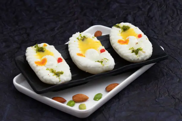 Photo of Cham Cham Mithai Also Called Rasgulla Malai Chaap, Chomchom Or Rosogolla Chamcham Is Made Of Milk, Mawa, Khoya, Pista, Kesar, Khova, Paneer, Chenna, Chhena, Dry Fruits Stuffing And Dunked In Chasni