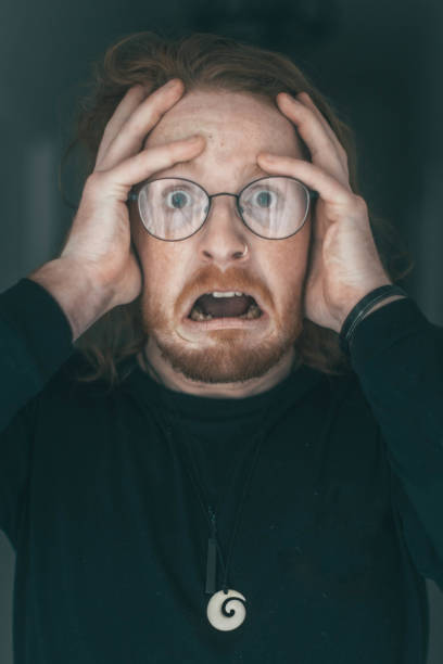 istock Terrified, red haired, glasses wearing man 1415716066