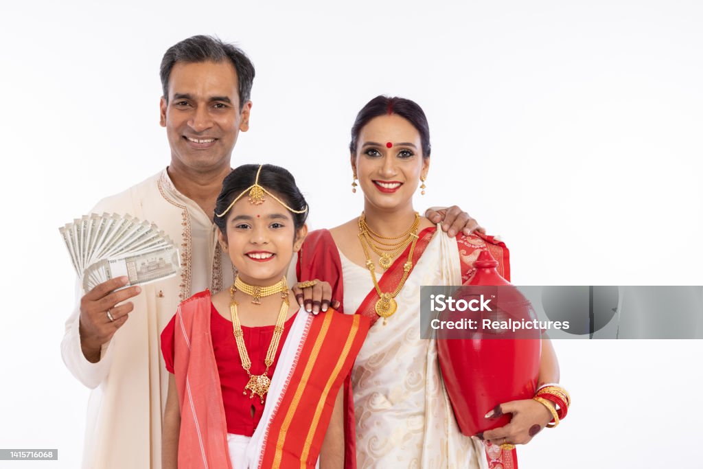 Bengali family in traditional clothing holding 500 rupees banknotes and piggy bank Happy bengali parents with girl holding 500 rupees banknotes and antique matir bank 40-49 Years Stock Photo