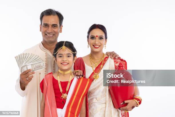Bengali Family In Traditional Clothing Holding 500 Rupees Banknotes And Piggy Bank Stock Photo - Download Image Now