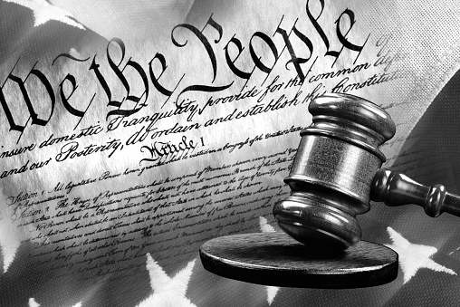 We the People with justice of the gavel in black and white.