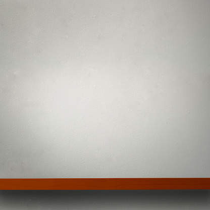 Close-up of empty wooden shelf against white concrete wall.