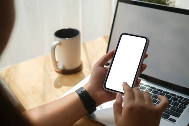 istock Close up view woman holding smart phone with empty screen for your text message or information content. 1415723978