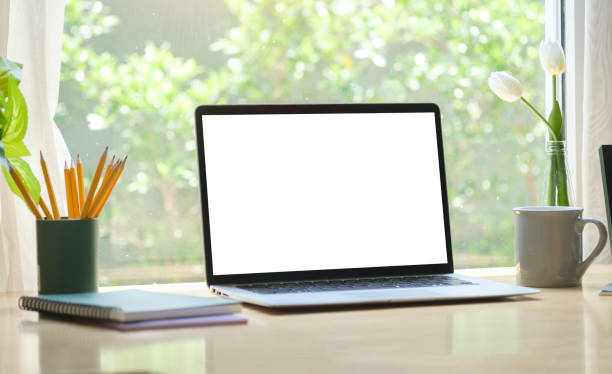 istock Home office desk with computer laptop, coffee cup and houseplant on wood table. 1415724018