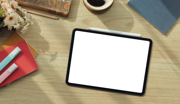 istock Top view modern workspace with digital tablet, stylus pen and coffee cup on wood table. 1415724241