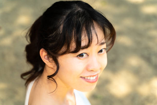 istock young woman in the park 1415724525