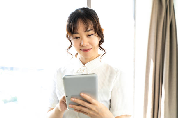 istock woman looking at tablet 1415724755