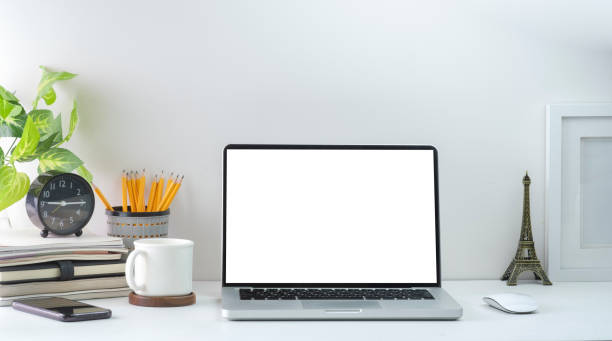 istock Computer laptop with empty screen, coffee cup, and potted plant on table. Home office. 1415725831