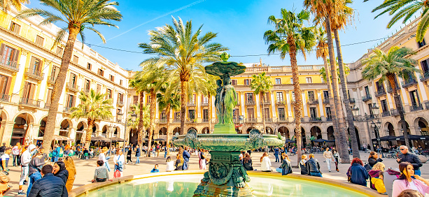 Barcelona, Spain - 15 April, 2022: Panorama of Placa Reial in Barri Gotic of Barcelona, people resting on a square.
