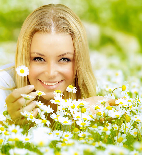 istock Beautiful girl enjoying daisy field 141572622