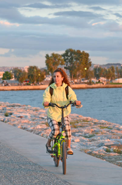 A woman smiling while riding a bicycle in izmir