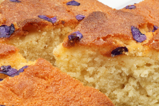 Sweet violet and lemon drizzle cake pieces to show the crumb
