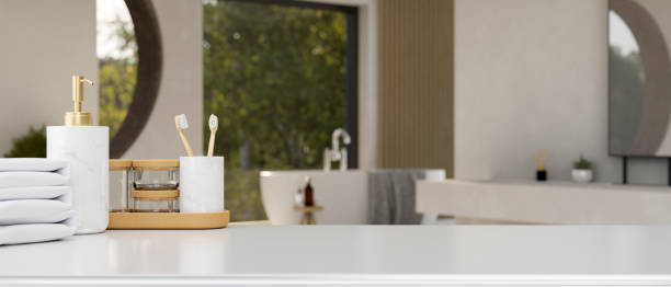 istock Luxury white tabletop with bathroom products and copy space over blurred bathroom background 1415728274