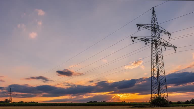 Time lapse panorama of power transmission towers in the fields