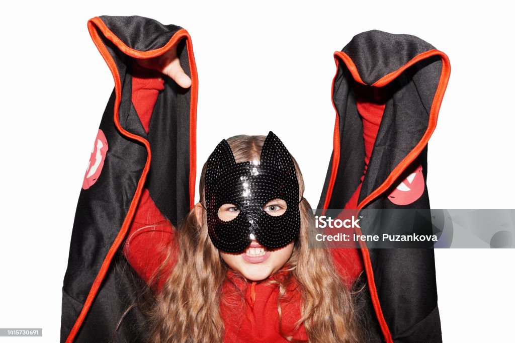 Funny little girl wearing Helloween carnival costume isolated on white background. Having fun on Halloween celebration. 8-9 Years Stock Photo
