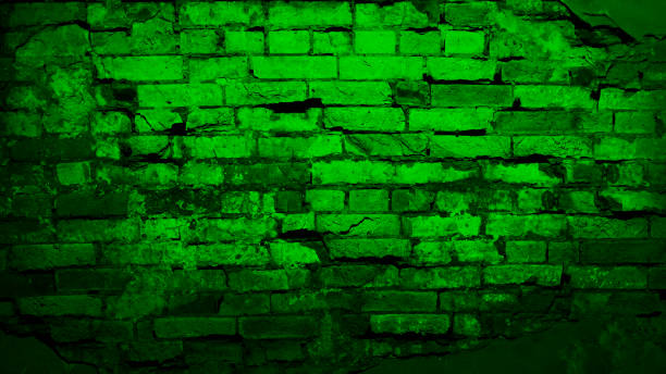 istock Black green brick wall. Close-up. Toned grunge background with space for design. 1415732104