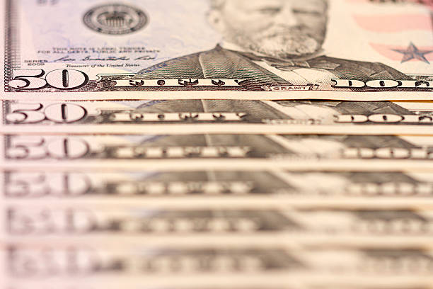 istock US Fifty Dollar Bills In A Vertical Pile/Spread 141573220
