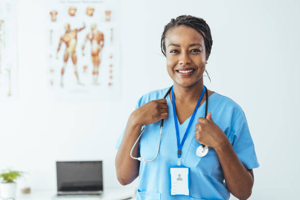 istock A nurse wearing blue scrubs smiles confidently at the camera. 1415733410