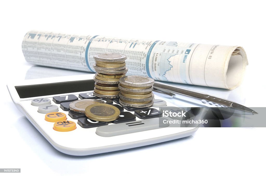 Business Success Calculator with Euro money coins and ball pen in front of a stock market report Balance Stock Photo