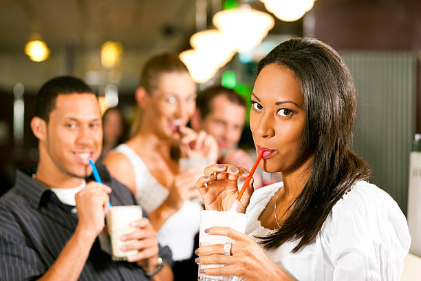 istock Friends drinking milkshakes in a bar 141573474