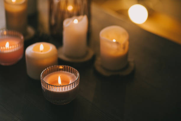 istock Candles in glasses on wooden table. 1415734747
