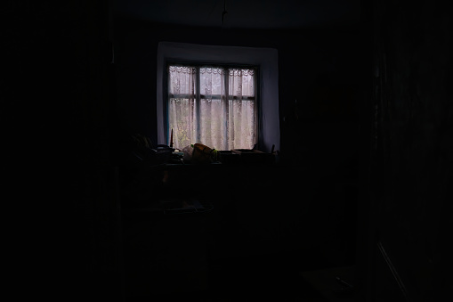 Mysterious mood created by white light in the window
