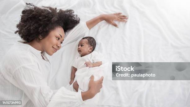 Closeup Portrait Of Beautiful Young African American Mother Day Girl Kiss Healthy Newborn Baby Sleep In Bed Flat Lay Copy Space Healthcare Medical Love Black Woman Lifestyle Mothers Day Top View Stock Photo - Download Image Now