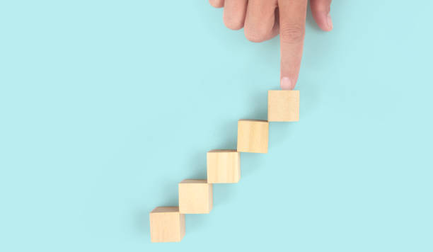 istock Business connecting piece of multi wood chart blocks steps in hand 1415735195
