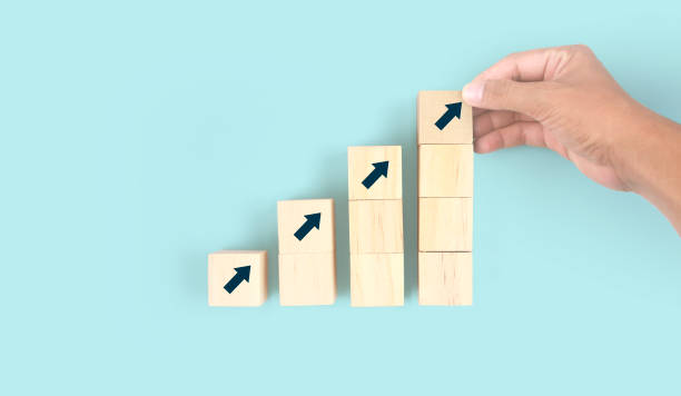 istock Business connecting piece of multi wood chart blocks steps in hand 1415735204