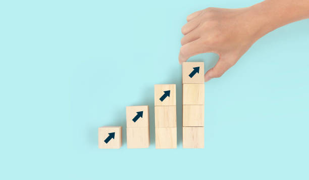 istock Business connecting piece of multi wood chart blocks steps in hand 1415735214